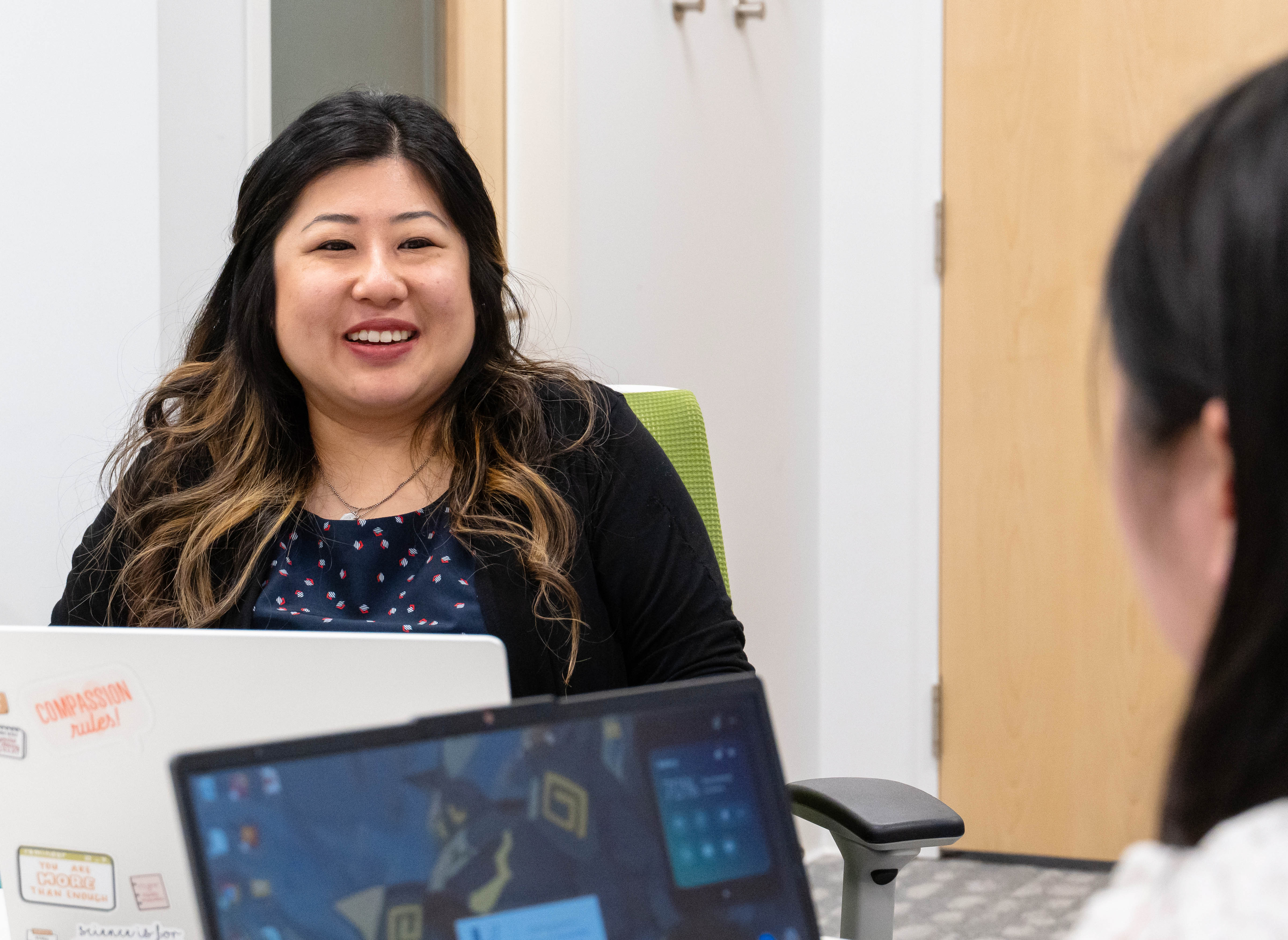 Professor Odilia Yim speaking to a student