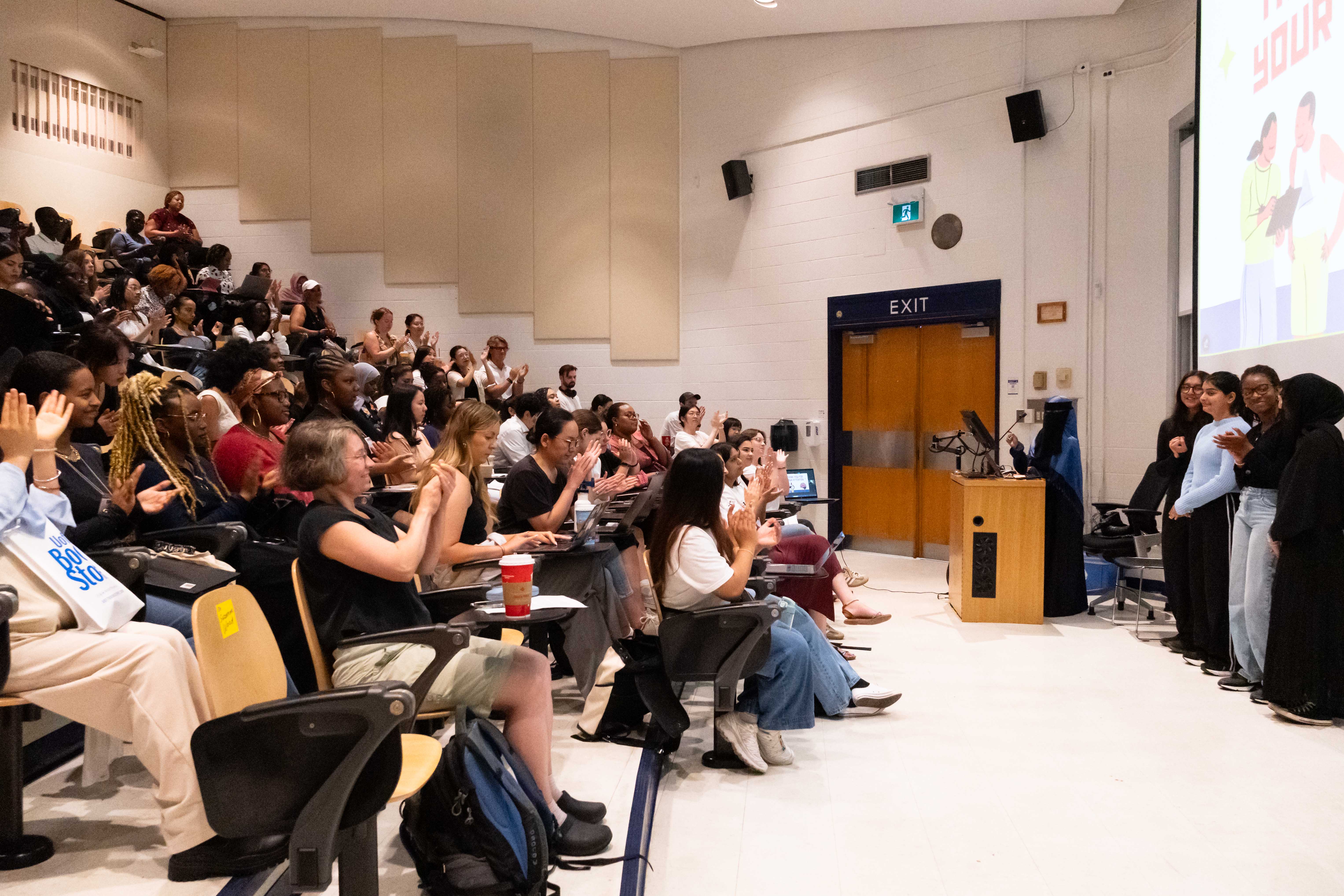Attendees applaud a group of SPRINT participants after they present their research proposal.
