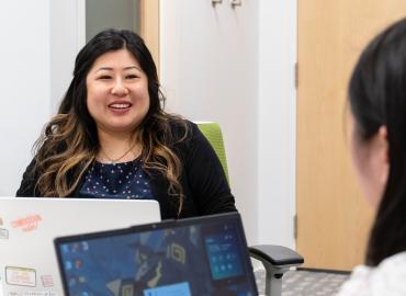 Professor Odilia Yim speaking to a student