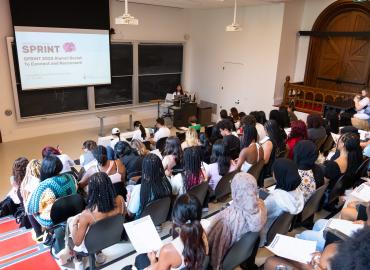 SPRINT participants gather in a classroom at University College for the first day of the program.