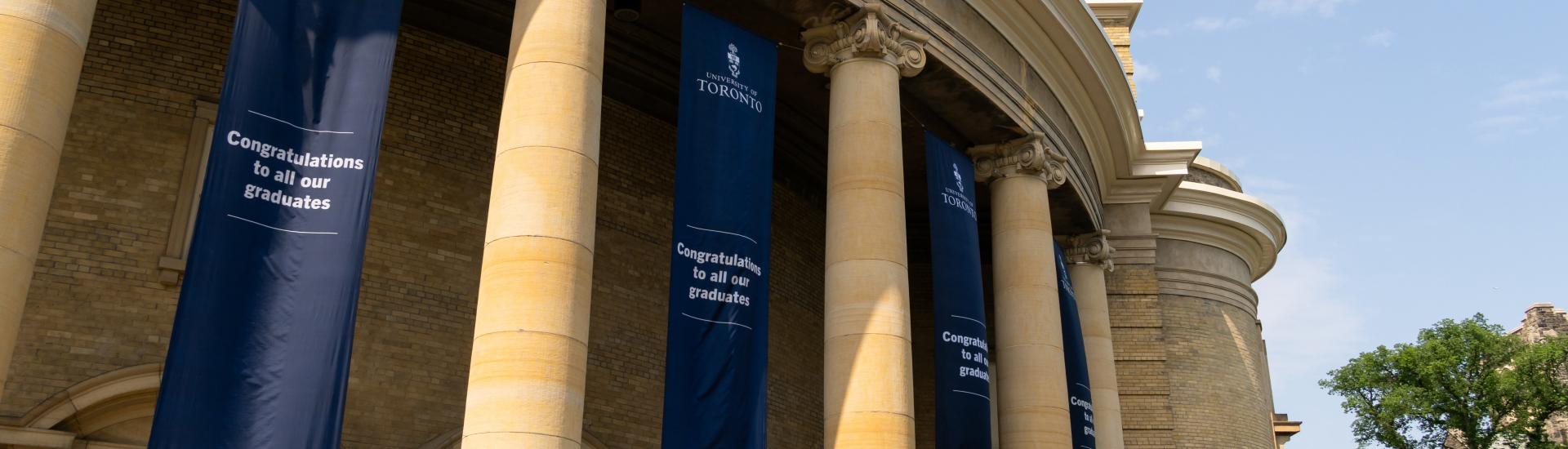 Convocation Hall at the University of Toronto with navy blue banners that read, "Congratulations to all our graduates"